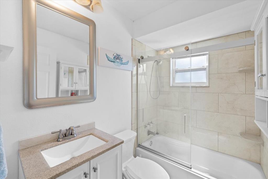 4498 Plumosa Street Spring Hill, FL 34607 - Photo 16 of 24 a bathroom with a sink toilet and shower