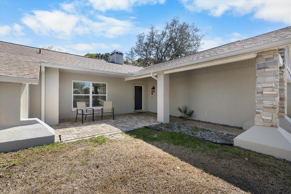4498 Plumosa Street Spring Hill, FL 34607 - Photo 21 of 24 a front view of a house with a yard and garage