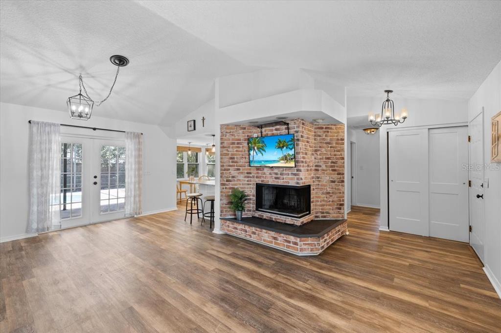 4498 Plumosa Street Spring Hill, FL 34607 - Photo 3 of 24 a living room with furniture and a fireplace