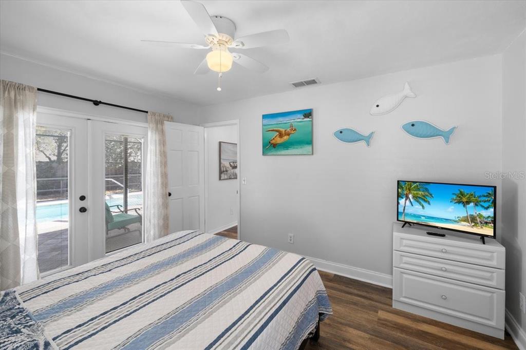 4498 Plumosa Street Spring Hill, FL 34607 - Photo 9 of 24 a bedroom with a bed and a chandelier