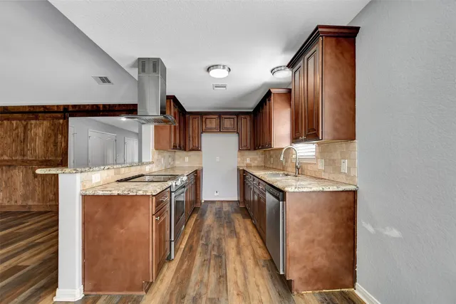 a kitchen with a stove top oven and cabinets