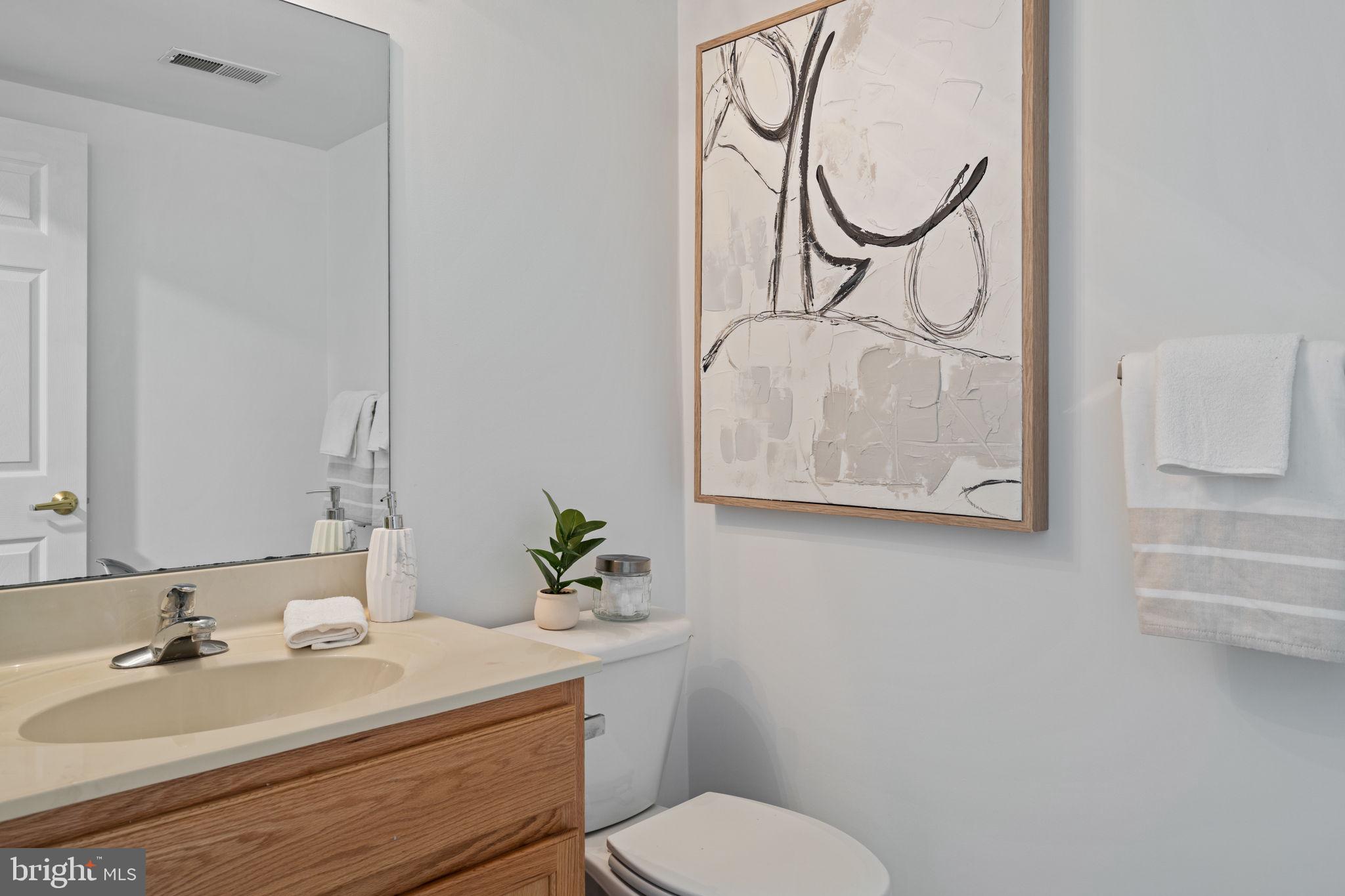 2341 Wallace Street, Unit B Philadelphia, PA 19130 - Photo 12 of 45 a bathroom with a sink mirror vanity and toilet