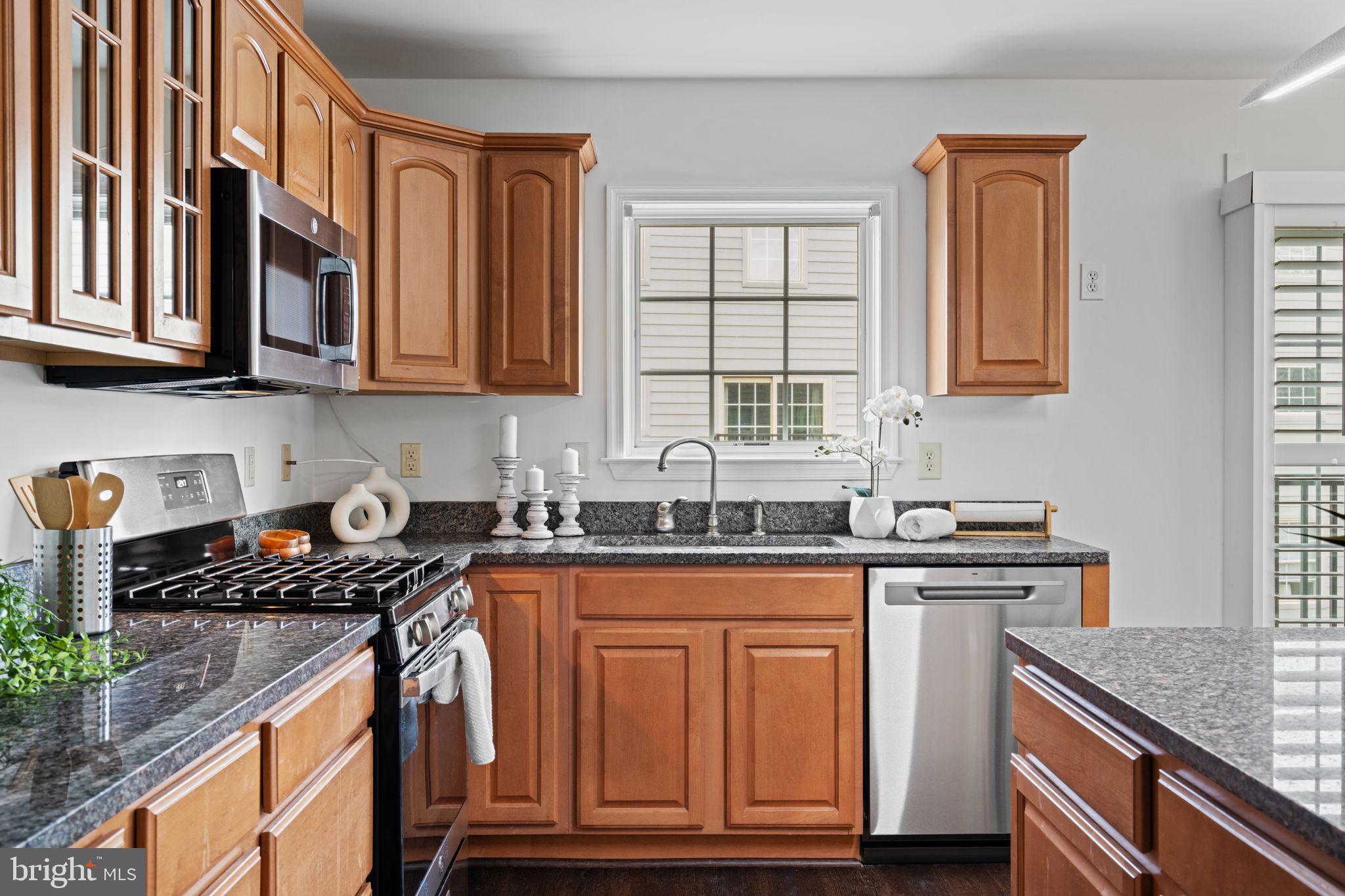 2341 Wallace Street, Unit B Philadelphia, PA 19130 - Photo 17 of 45 a kitchen with stainless steel appliances granite countertop a stove sink and cabinets
