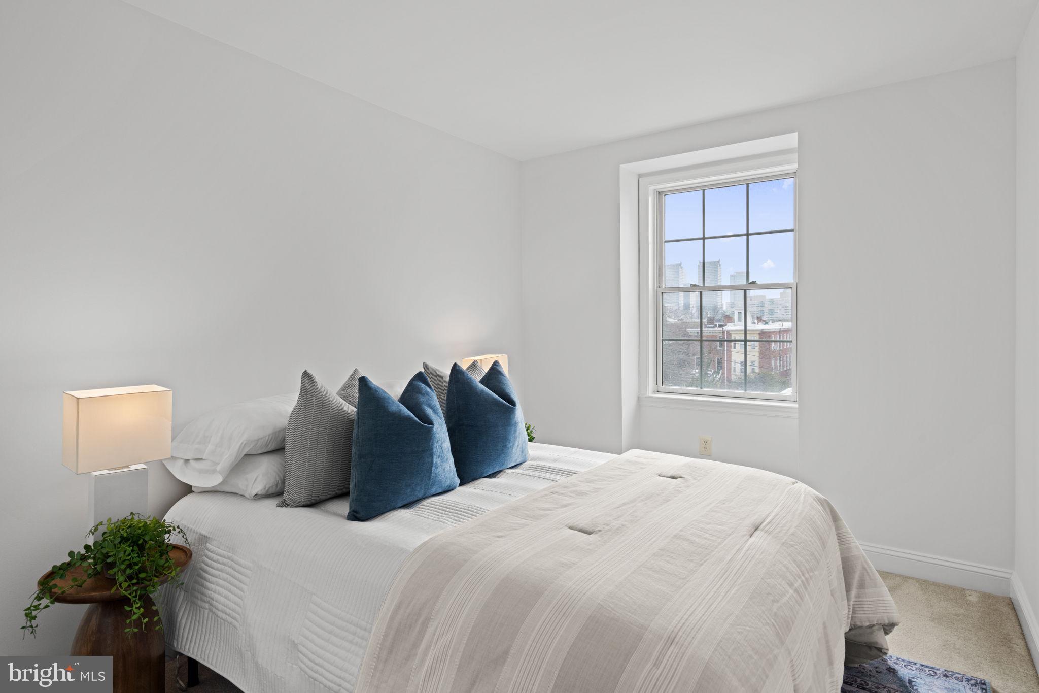 2341 Wallace Street, Unit B Philadelphia, PA 19130 - Photo 25 of 45 a bedroom with a bed and a window