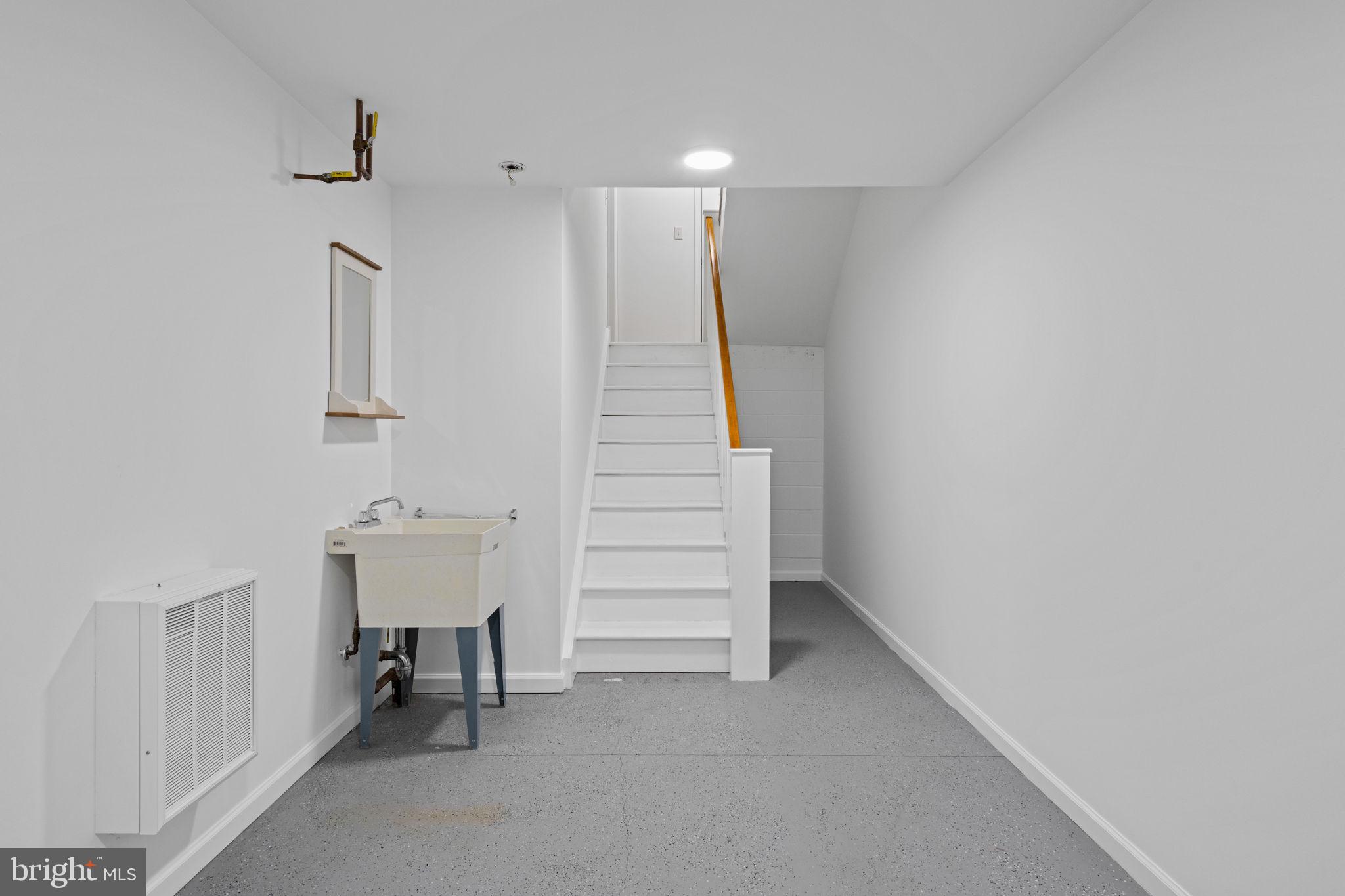 2341 Wallace Street, Unit B Philadelphia, PA 19130 - Photo 37 of 45 a view of an empty room with stairs and a hallway