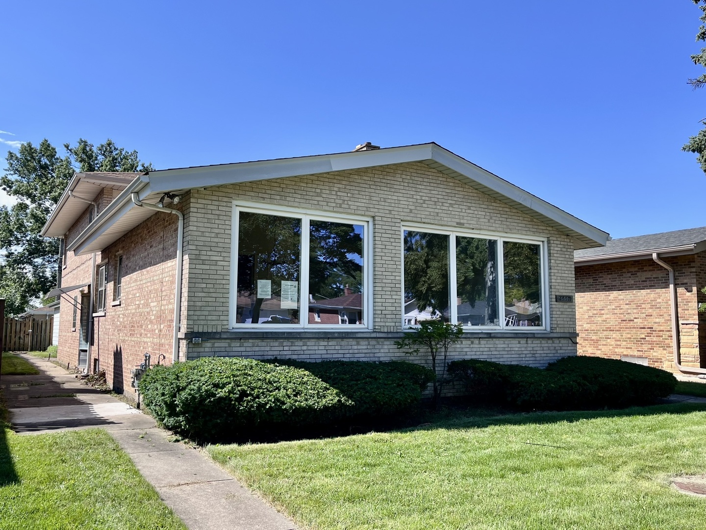 4939 Fargo Avenue Skokie, IL 60077 - Photo 2 of 20 a front view of a house with a yard and potted plants