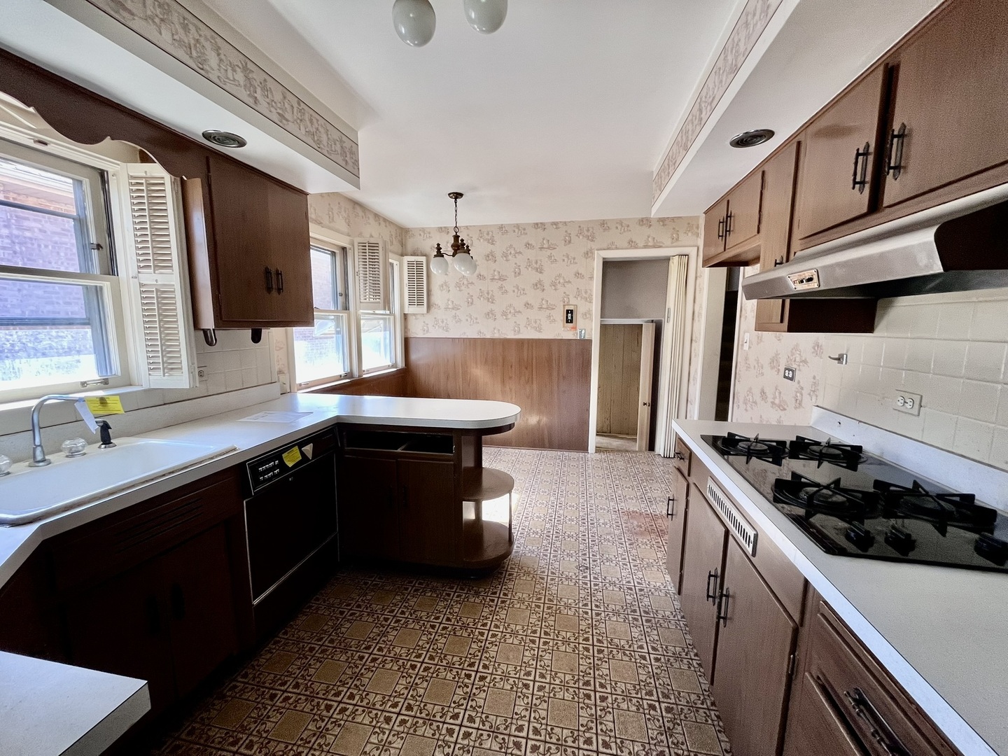 4939 Fargo Avenue Skokie, IL 60077 - Photo 7 of 20 a kitchen with a sink and a stove top oven
