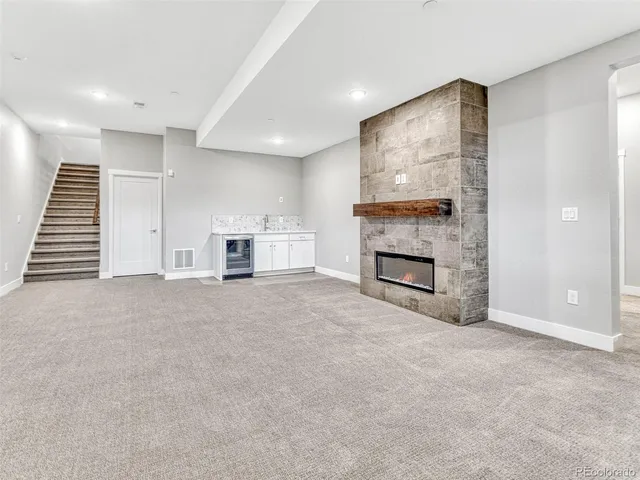 a view of a livingroom with a fireplace and staircase