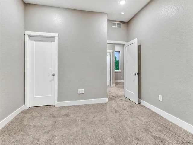 a view of a balcony with wooden floor and fence