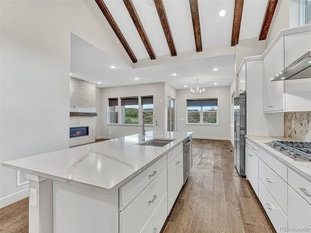 a large kitchen with stainless steel appliances granite countertop a large stove a sink dishwasher and a refrigerator