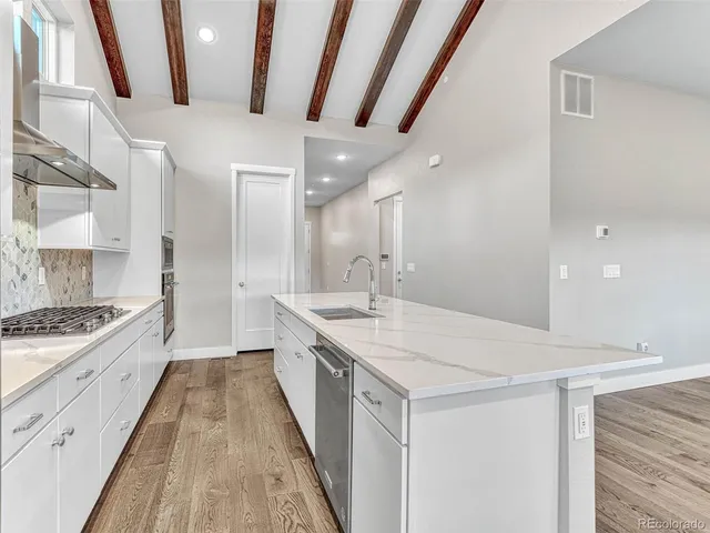 a large white kitchen with a large window