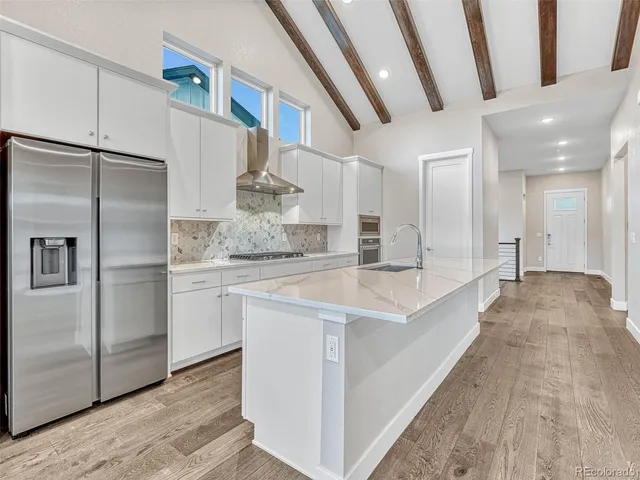 a kitchen with stainless steel appliances a refrigerator and a sink