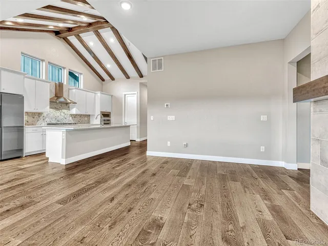 a view of a kitchen with a sink and cabinets