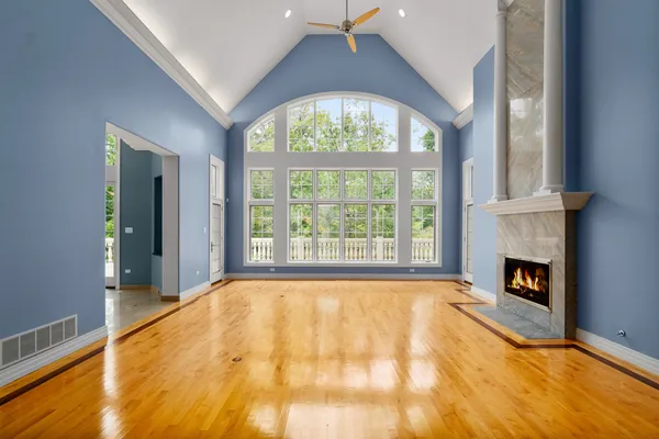 a view of a livingroom with wooden floor and a fireplace