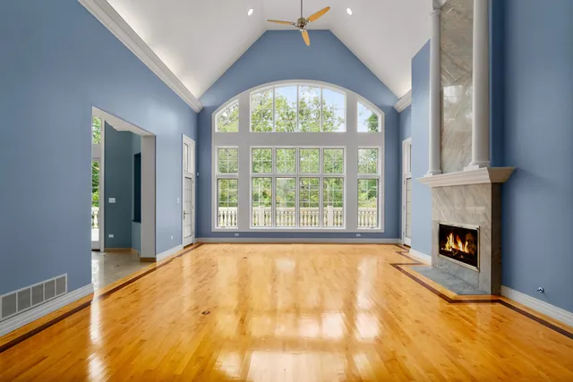 a view of a livingroom with wooden floor and a fireplace