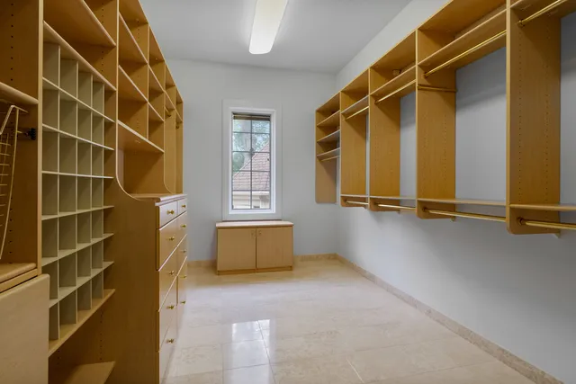 a large kitchen with stainless steel appliances granite countertop a stove and a large window