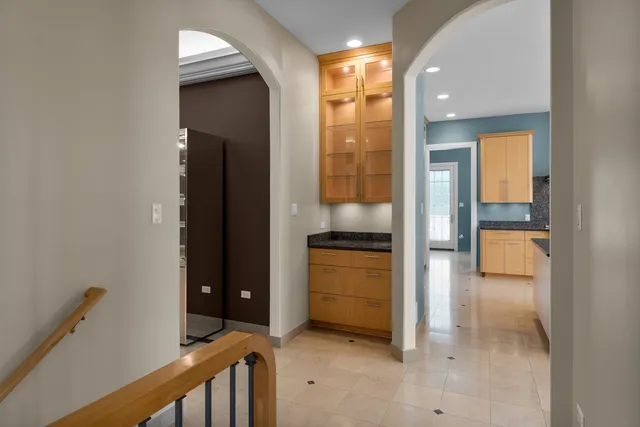 a kitchen with stainless steel appliances granite countertop a sink a stove and a wooden floors