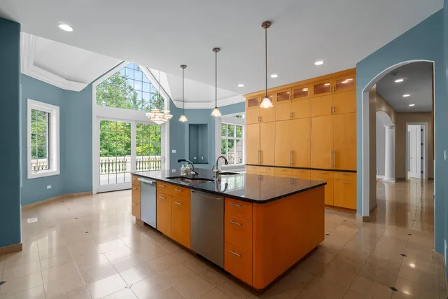 a kitchen with stainless steel appliances granite countertop a sink and a refrigerator