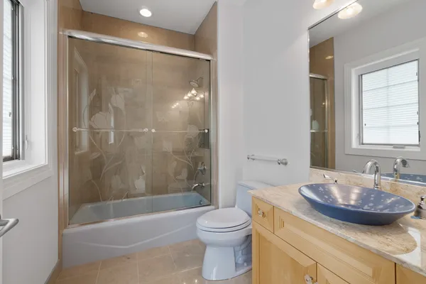a bathroom with a sink a toilet and mirror