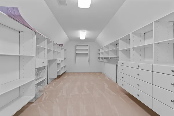an empty room with furniture and a large window