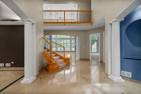a view of an empty room with a window and a fireplace