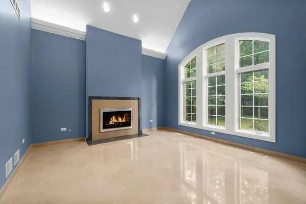 a view of an empty room with a fireplace and a large window
