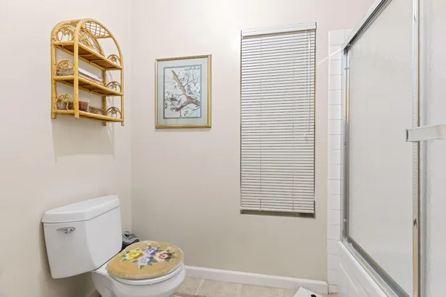 a bathroom with a toilet a sink and a window