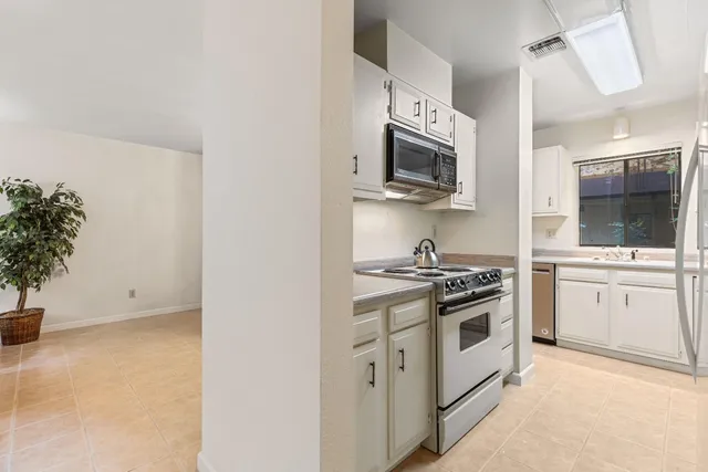 a kitchen with stainless steel appliances white cabinets and a stove