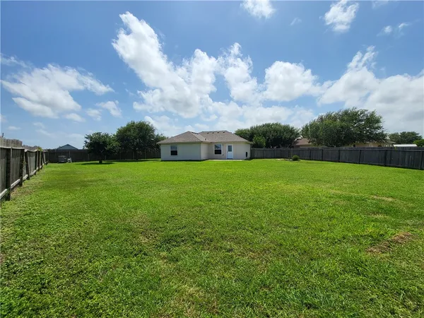 a view of a big yard with large trees