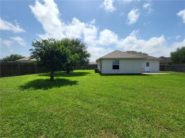 a view of house with backyard