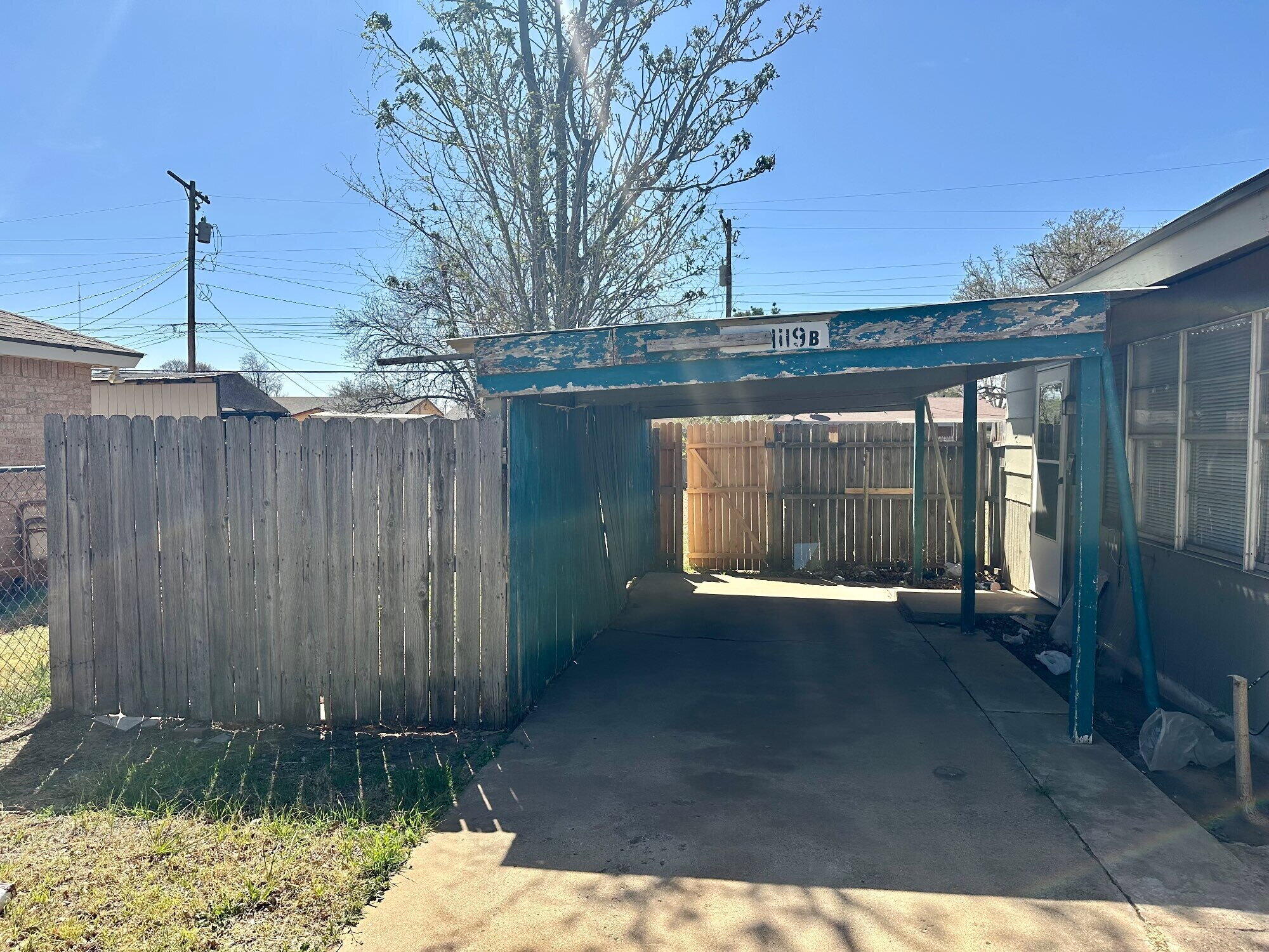 1119 46th Street, Unit B Lubbock, TX 79412 - Photo 2 of 9 a front view of a house with a yard