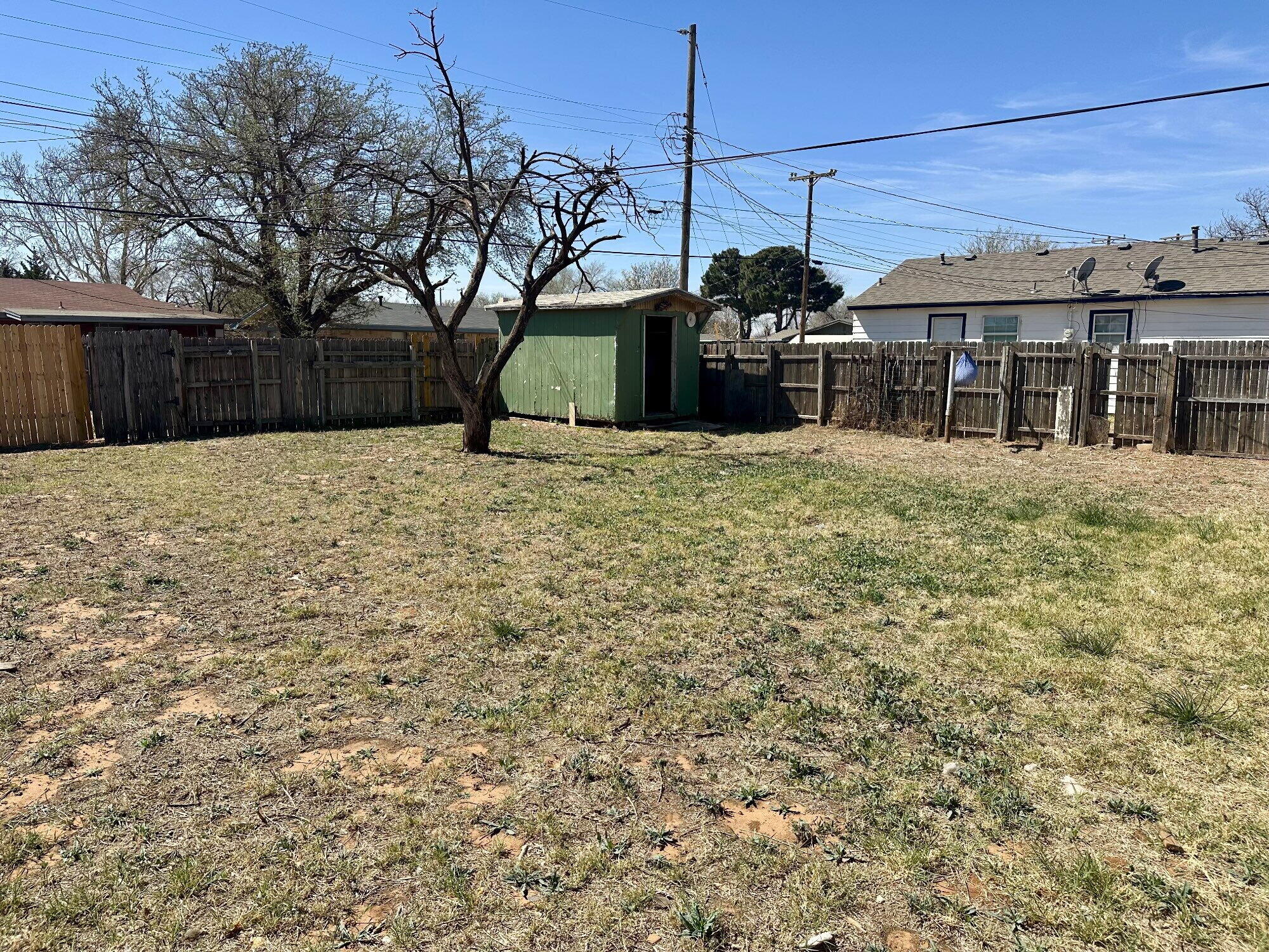 1119 46th Street, Unit B Lubbock, TX 79412 - Photo 8 of 9 a front view of a house with a yard