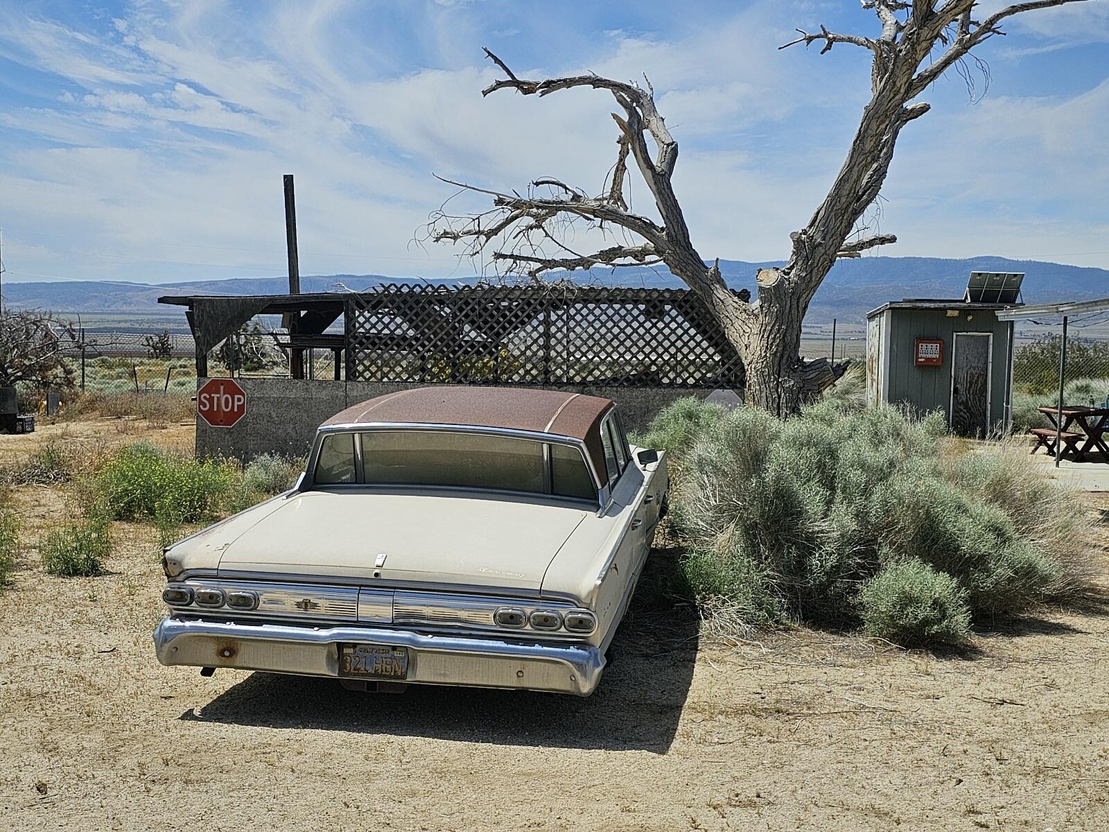 Gaskell Road Rosamond, CA 93560 - Photo 29 of 50 a roof deck with table and chairs with wooden fence
