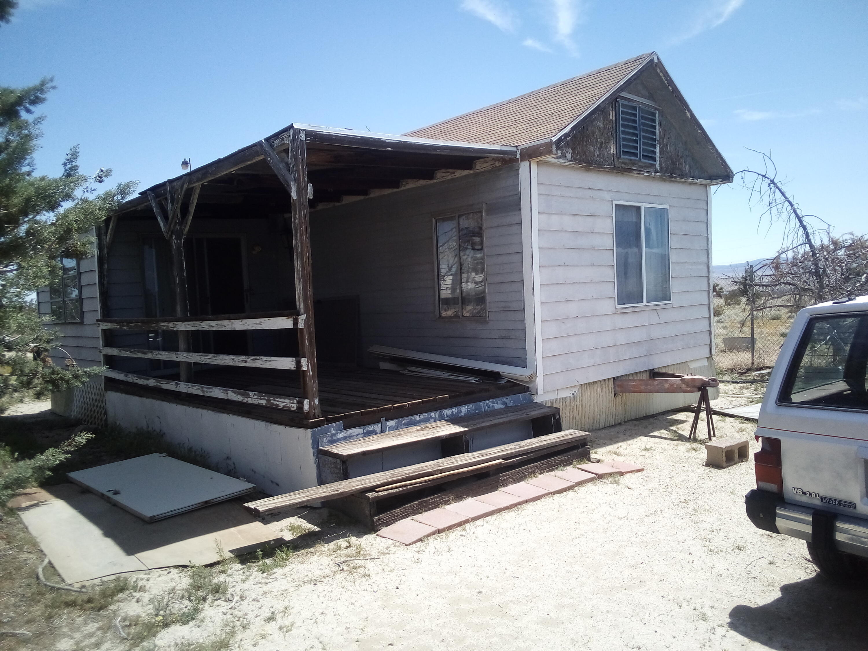 Gaskell Road Rosamond, CA 93560 - Photo 3 of 50 a view of house with wooden fence and a bench