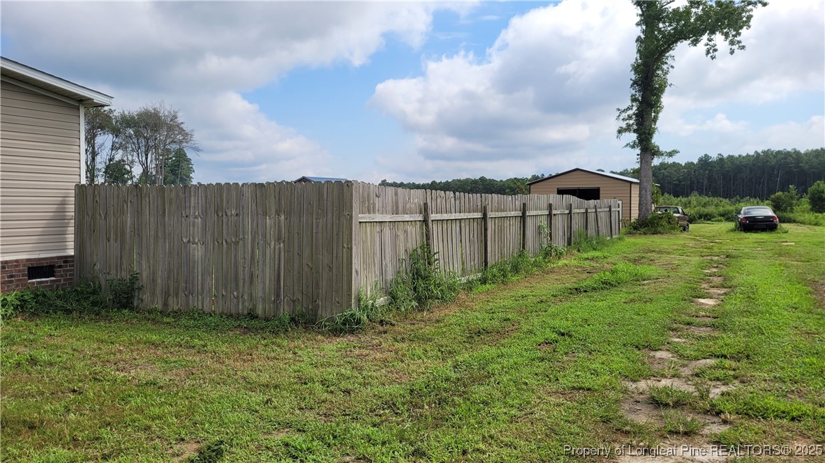 1235 Martin Road St. Pauls, NC 28384 - Photo 21 of 28 a view of a backyard with large trees