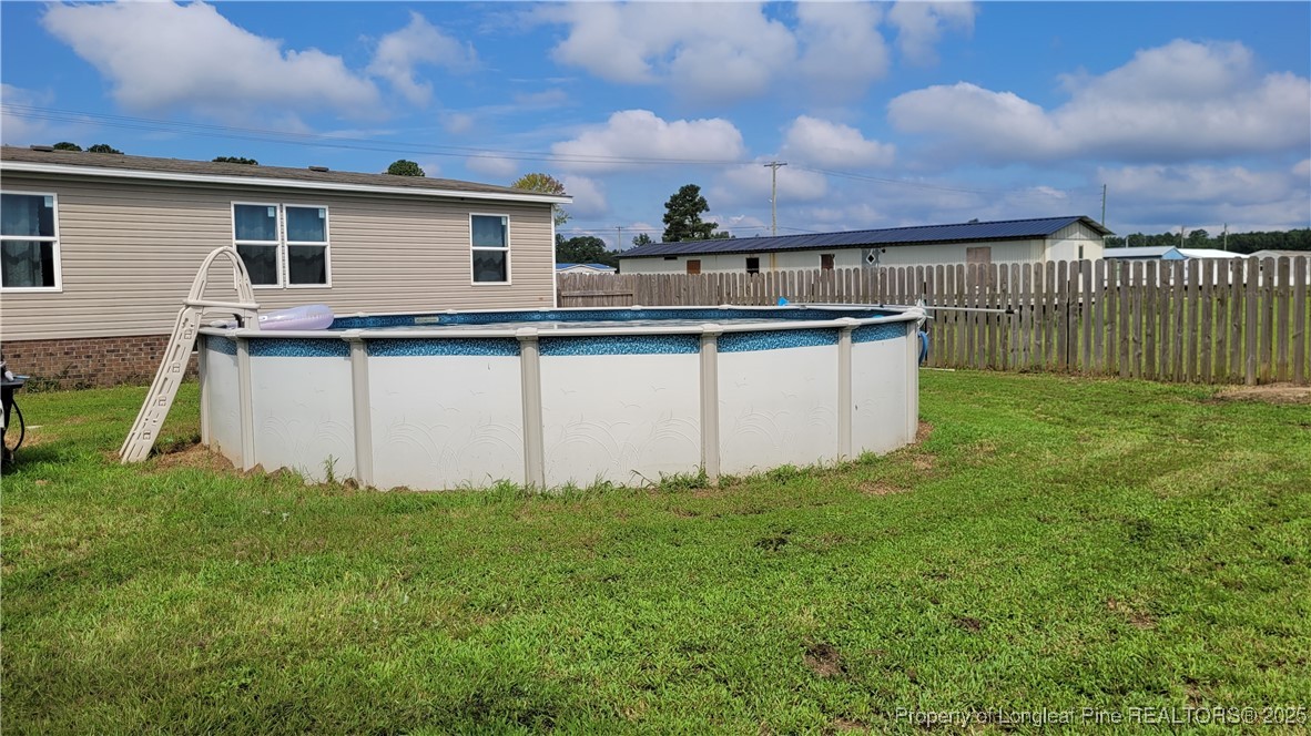 1235 Martin Road St. Pauls, NC 28384 - Photo 26 of 28 a view of a house with a yard and a large tree