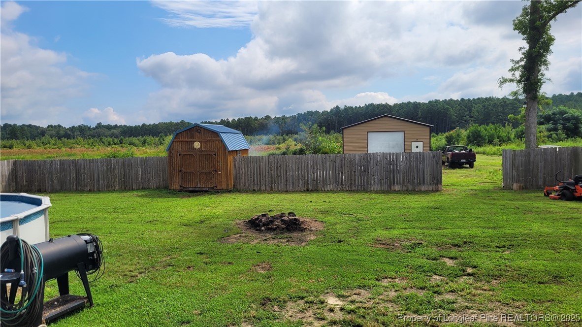 1235 Martin Road St. Pauls, NC 28384 - Photo 27 of 28 a backyard of a house with lots of green space and garden