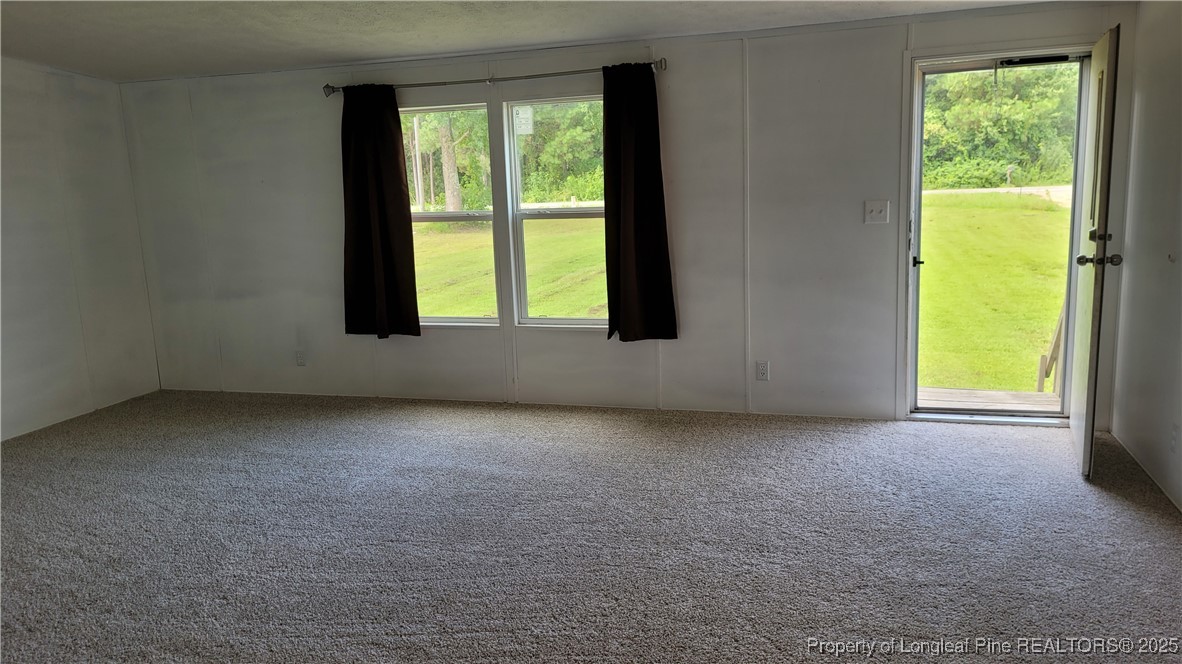1235 Martin Road St. Pauls, NC 28384 - Photo 4 of 28 an empty room with a window and a fireplace