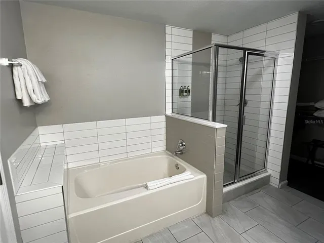 a bathroom with a bathtub and a shower