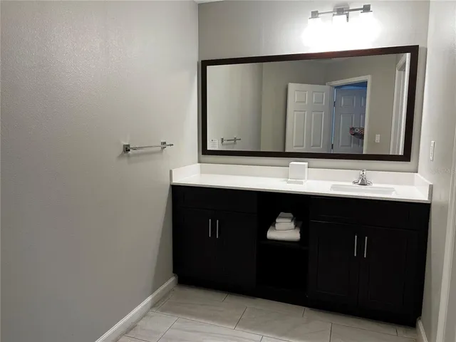 a bathroom with a sink vanity and a mirror