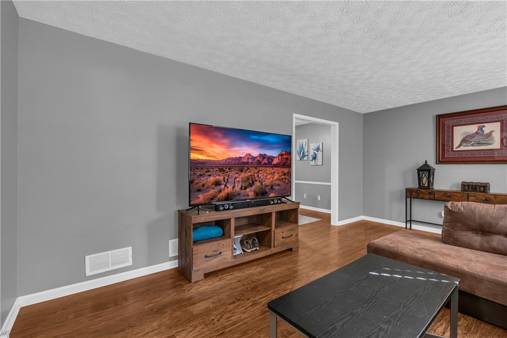4907 Habersham Ridge Southwest Lilburn, GA 30047 - Photo 11 of 76 a living room with furniture and a flat screen tv