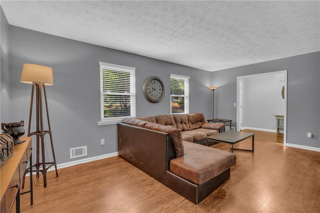4907 Habersham Ridge Southwest Lilburn, GA 30047 - Photo 13 of 76 a living room with furniture and a window