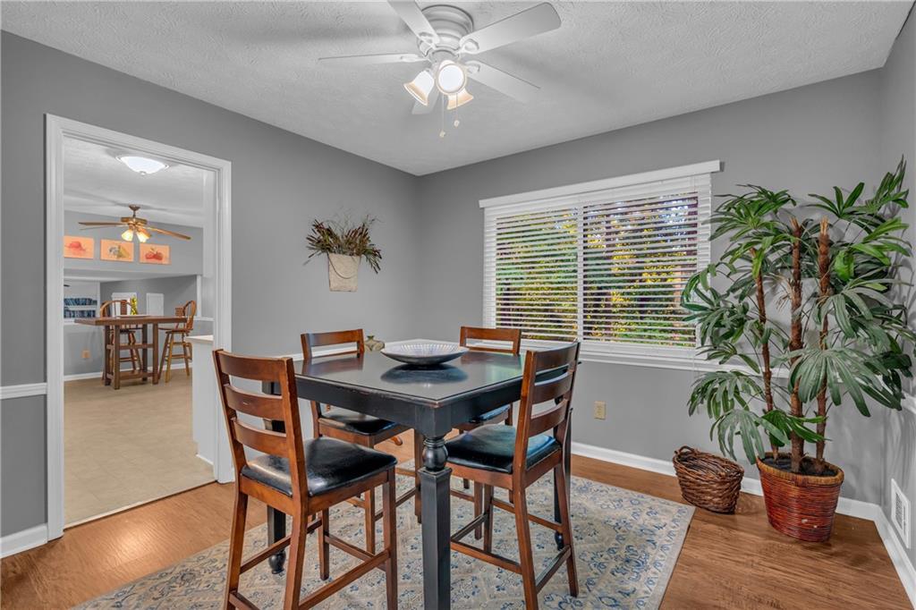 4907 Habersham Ridge Southwest Lilburn, GA 30047 - Photo 16 of 76 a view of a dining room with furniture window and wooden floor