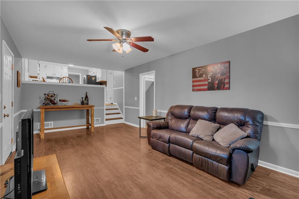 4907 Habersham Ridge Southwest Lilburn, GA 30047 - Photo 28 of 76 a living room with furniture and a wooden floor