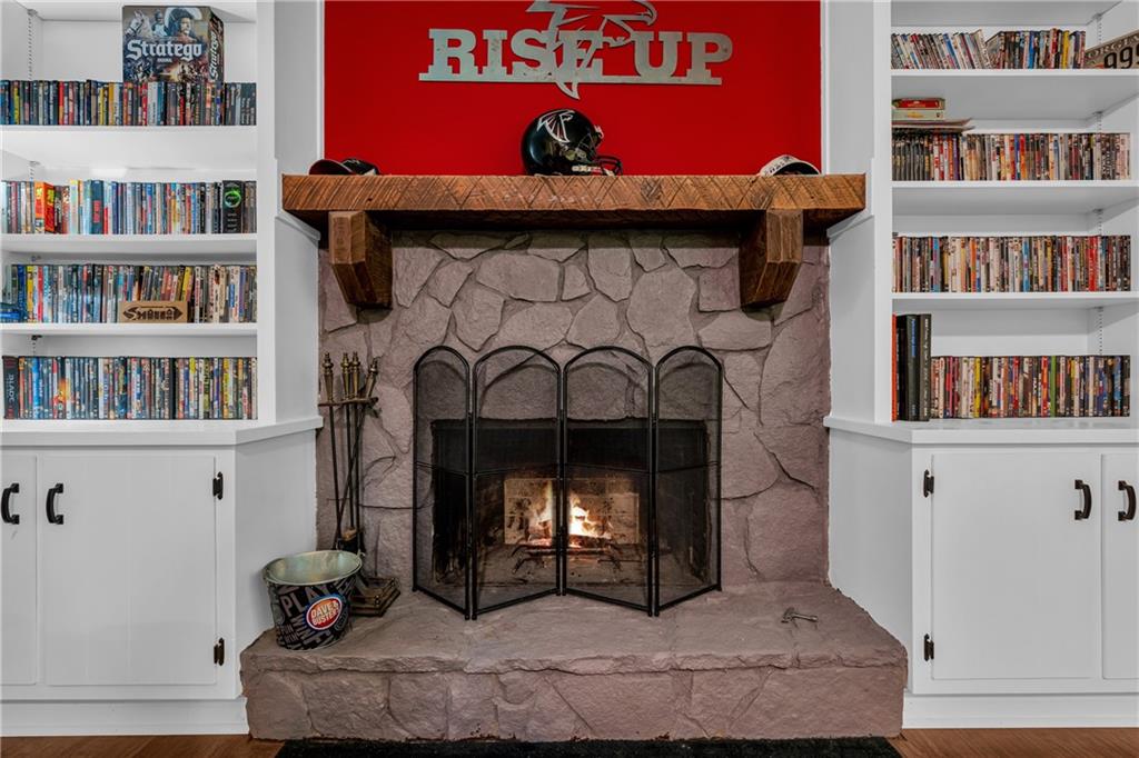 4907 Habersham Ridge Southwest Lilburn, GA 30047 - Photo 31 of 76 a living room with a fireplace and a book shelf