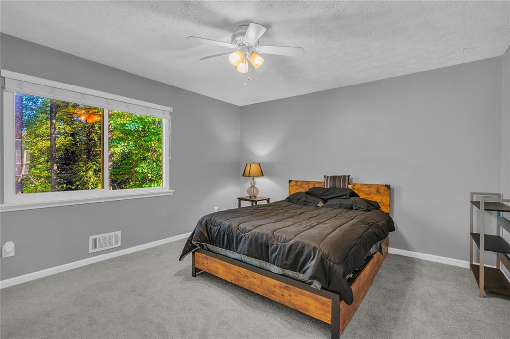 4907 Habersham Ridge Southwest Lilburn, GA 30047 - Photo 36 of 76 a bedroom with a bed and window