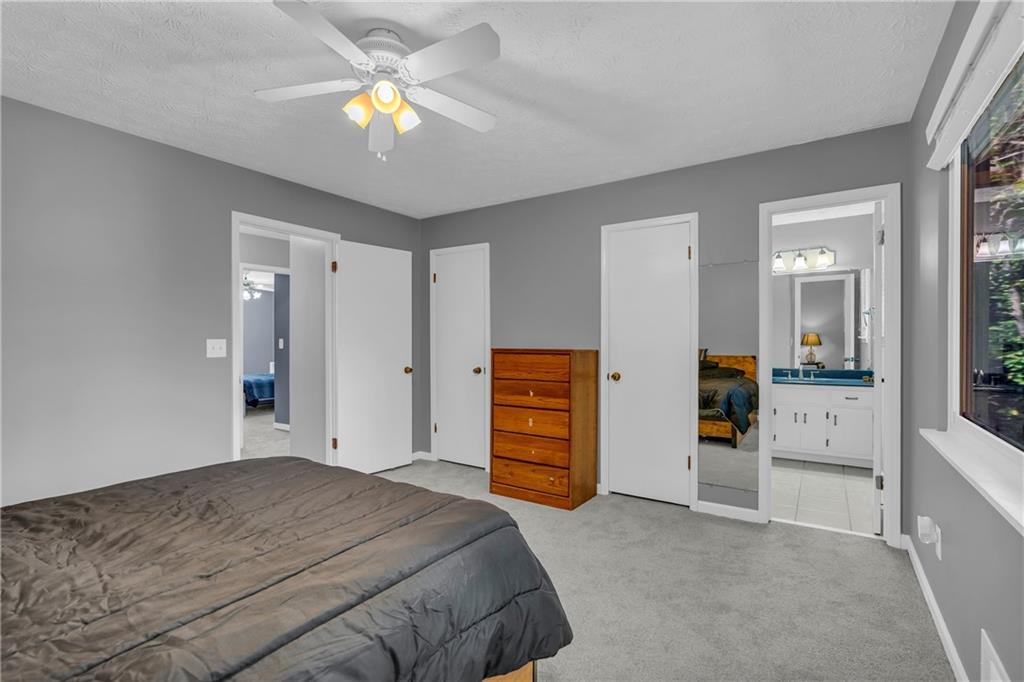 4907 Habersham Ridge Southwest Lilburn, GA 30047 - Photo 39 of 76 a bedroom with a bed and a chandelier