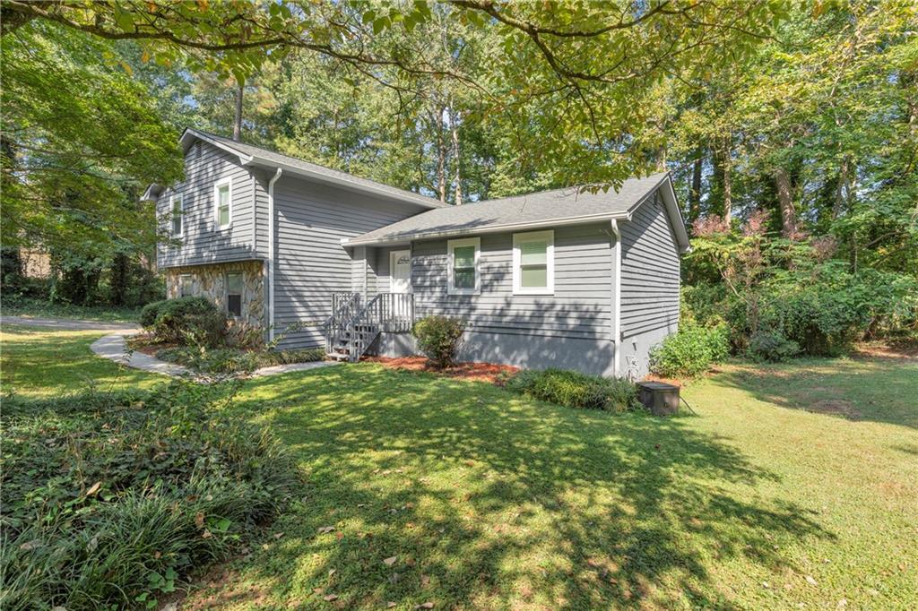 4907 Habersham Ridge Southwest Lilburn, GA 30047 - Photo 4 of 76 a view of a yard in front of house