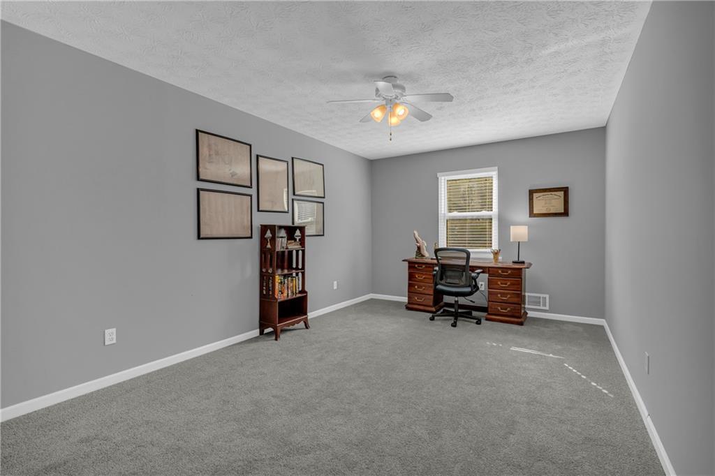 4907 Habersham Ridge Southwest Lilburn, GA 30047 - Photo 41 of 76 a living room with furniture and a chandelier