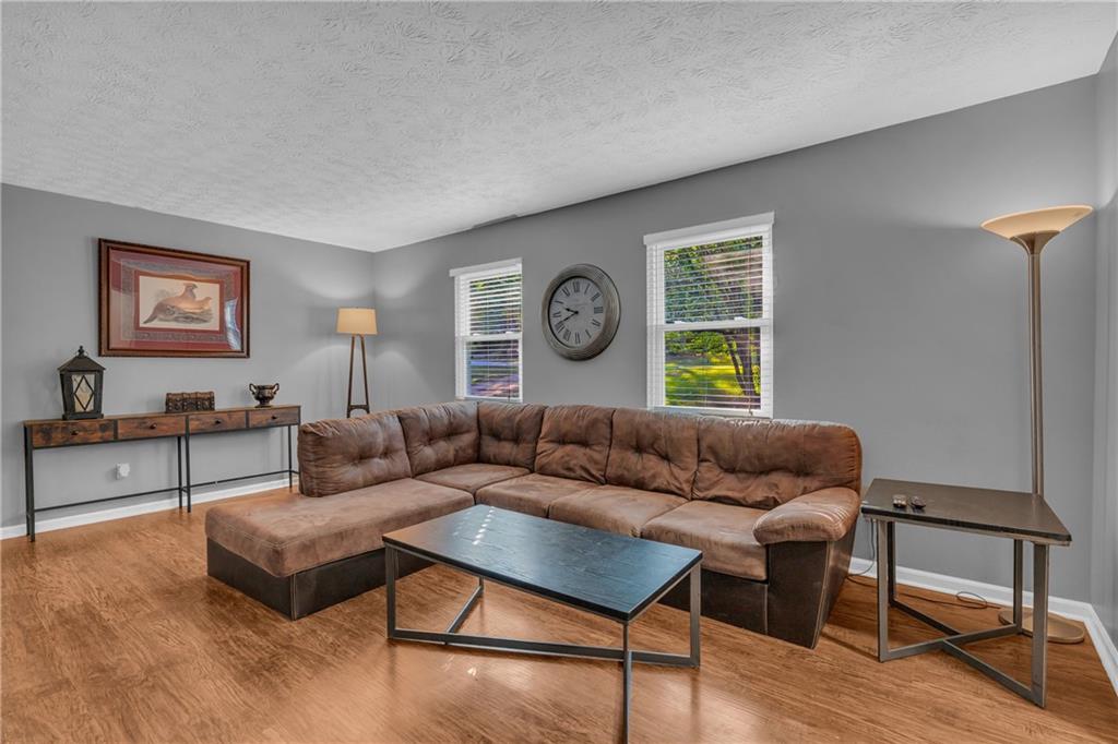 4907 Habersham Ridge Southwest Lilburn, GA 30047 - Photo 9 of 76 a living room with furniture and wooden floor